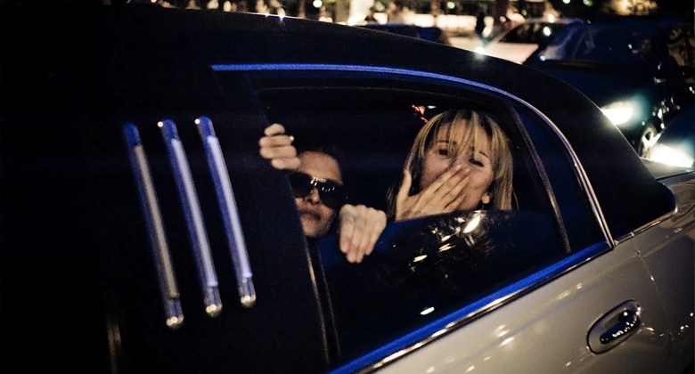 Girl blowing kisses out of the Chicago limousine window